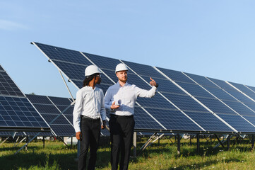 Solar farm engineers discussing renewable energy project