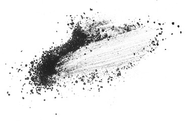 Top view of black charcoal particles on a white background. Activated charcoal powder for a face mask. Effect fragments explosion.