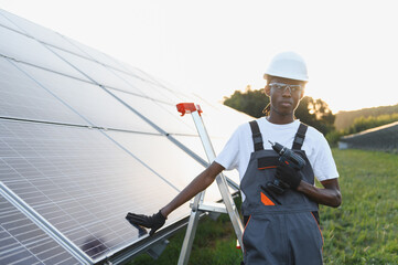 Technician installing solar panel, working with green energy