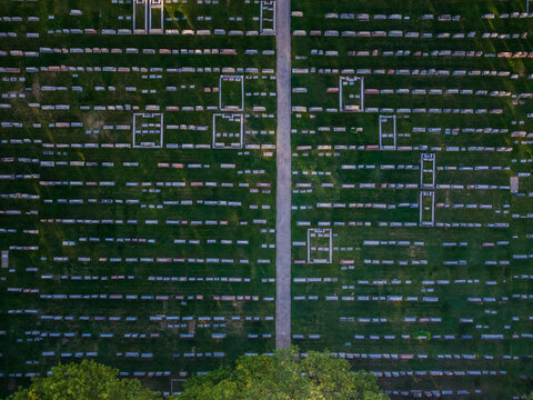 Aerial view of rows of white grave stones stand in stark contrast against the verdant green grass in a cemetery, Boston, Massachusetts, United States.