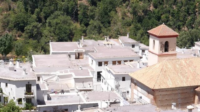 Roofs and bell tower of the Church of the Holy Cross in Pampaneira, Alpujarra Granadina, Andalusia. The church is characterized by its Mud&eacute;jar and Baroque architecture.