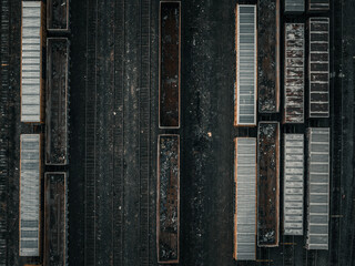 Aerial view of railway cars and tracks create a mesmerizing pattern of dark and light tones, highlighting the industrial landscape, Boston, Massachusetts, United States.