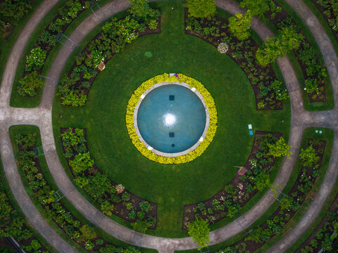 Aerial view of a serene fountain encircled by vibrant greenery and winding stone paths, a tranquil oasis in the city, Boston, Massachusetts, United States.
