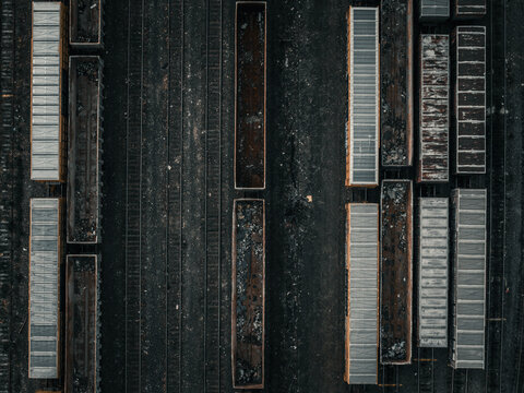 Aerial view of railway cars and tracks create a mesmerizing pattern of dark and light tones, highlighting the industrial landscape, Boston, Massachusetts, United States.