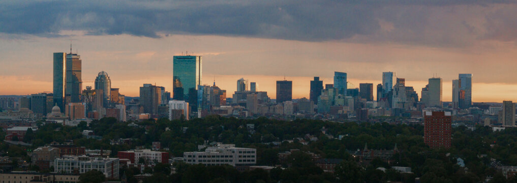 Aerial view of the John Hancock Tower and Prudential Center piercing the skyline as the golden sunset casts a warm glow, Boston, Massachusetts, United States.