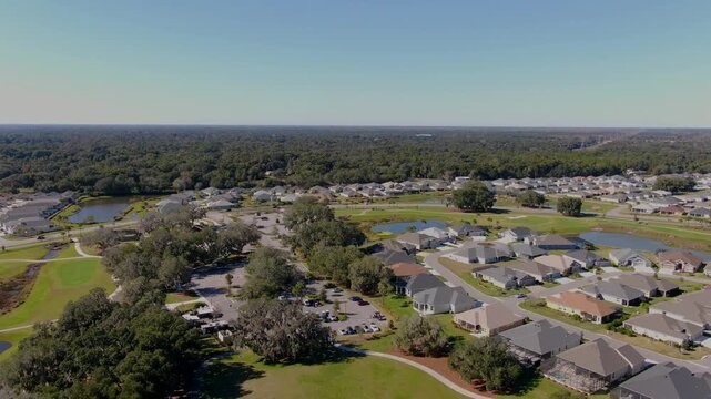 Still drone shot over Edna&rsquo;s on the Green in The Villages, FL, showing food trucks, parking, roadways, ponds, trees, and surrounding residential neighborhoods.