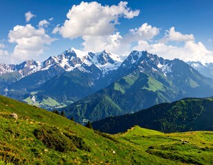 Obraz premium Scenic mountain range with green slopes under a vibrant blue sky with fluffy clouds
