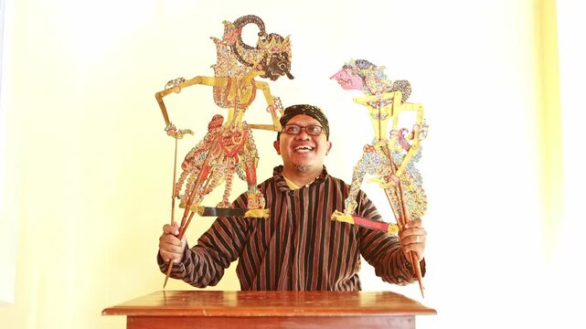 Javanese puppeteer performing with wayang kulit puppets