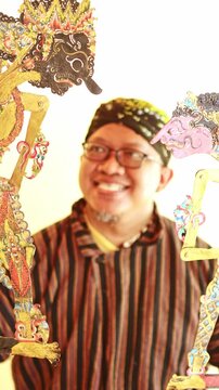 Indonesian puppeteer performing a wayang kulit show