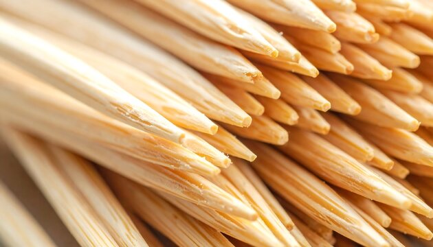 Macro of wooden toothpicks bundled together, focusing on their sharp tips and wood grain texture