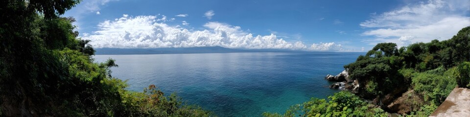 Tropical island panorama with clear blue water and lush green foliage