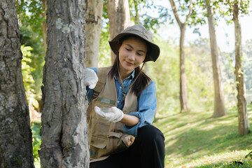 Female botanist researches grass and leaves in field to promote eco sustainability