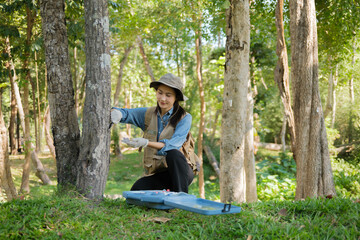 Female botanist researches grass and leaves in field to promote eco sustainability