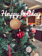 Happy Holidays Christmas Script Text Tree Background. festive message for the holiday season.