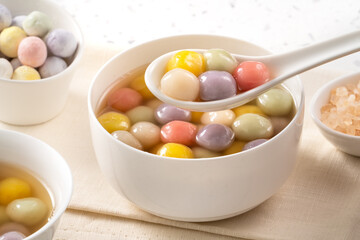 Colorful sweet glutinous rice balls tangyuan in sweet ginger syrup soup