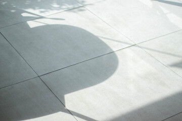 The shadow in the cafe reflects on the tiled floor