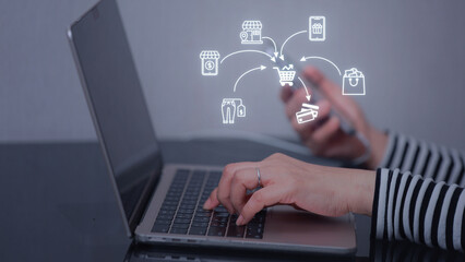 Focused women managing small owned ecommerce business online using laptop and digital network of retail icons