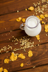 milk jug on wooden background top view