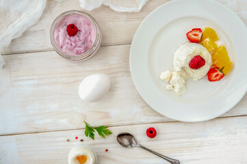 Ice cream with berries on white plate top view