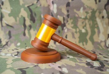 Judge's gavel against a military background. Legislation and law in the military sphere. Tribunal....
