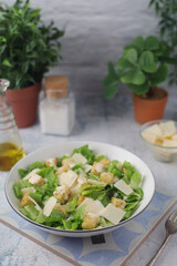A bowl with classic Caesar salad	