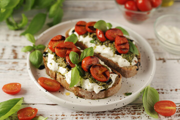 Italian sandwiches with grilled tomatoes, burrata cheese and pesto