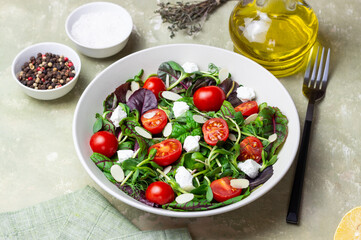 Salad with feta cheese, cherry tomatoes, and almonds. Healthy eating. Diet.