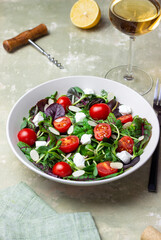 Salad with feta cheese, cherry tomatoes, and almonds. Healthy eating. Diet.