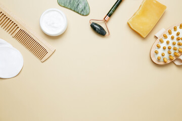 Skincare set with marble roller, gua sha, wooden body brush, facial cream and serum for natural beauty care