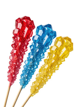 Hyper-detailed macro of glossy, wet-look ruby red, sapphire blue, and citrine yellow sugar crystal skewers isolated on a transparent background. Concept for sweet product photography
