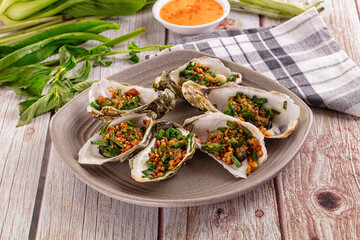 Gournet grilled oysters with onion and peanut
