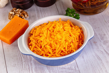 Yellow shredded cheddar cheese in the bowl