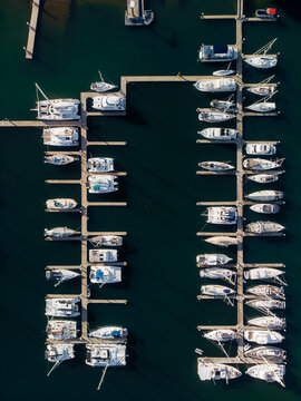 Aerial view of boats resting in the marina, their white hulls contrasting with the dark green water, Mooloolaba, Queensland, Australia.