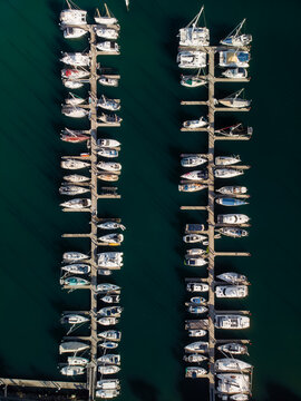 Aerial view of boats nestled in the marina, their white hulls contrasting with the deep turquoise water, Mooloolaba, Queensland, Australia.
