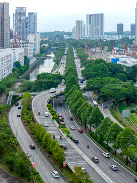 Aerial view of the Pan Island Expressway slicing through Toa Payoh, a ribbon of grey amidst a verdant landscape, Singapore, Singapore.