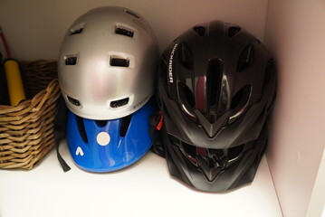 Fototapeta premium Collection of cycling helmets in various colors stacked neatly in a storage space