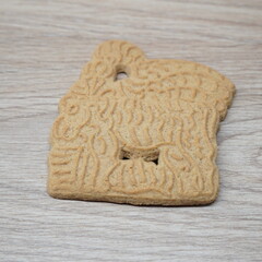 Traditional Speculaas cookie with intricate embossed patterns on a wooden surface