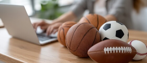 Online sports gambling on a laptop with sports symbols and digital network connections featuring various sports balls on a desk