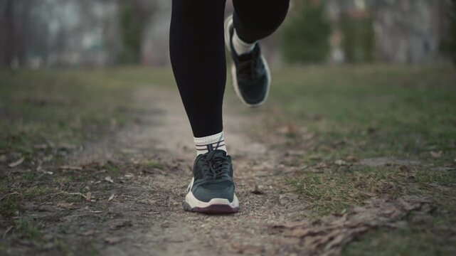 Closeup Of Running Shoes, White Runner Showing Foot Strike And Tread, Coach Gait Analysis, Product Test, Interval Drill, Podiatry Check, Race Prep. Dirt Path, Scuffed Soles, Elastic Laces, Rhythmic