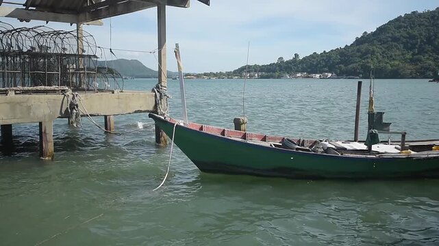 Wooden boat tied near fishing structure