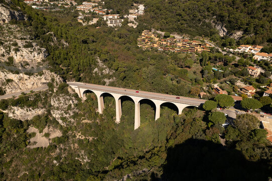 Aerial view of a striking viaduct soaring amidst the verdant hills, a modern marvel contrasting with the natural landscape, Eze, Provence-Alpes-Cote d'Azur, France.