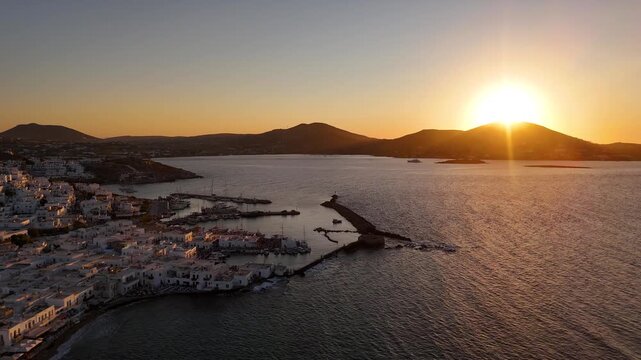 Beautiful Mediterranean island sunset. Golden sunlight reflects off whitewashed buildings. Paros, Greece