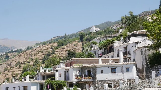 Traditional white houses of Pampaneira, in the Alpujarra region of Granada (Andalusia). Flat roofs of slate and cylindrical chimneys.