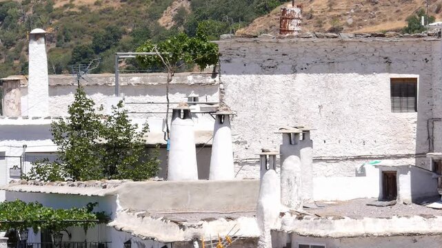 Traditional architecture of Pampaneira (Granada), with emphasis on the tall, cylindrical chimneys and the flat launa roofs, characteristic of the Alpujarra.