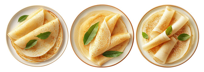 Thin golden crepes folded on a white plate with green leaves, isolated on white background, concept of breakfast