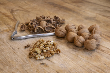 walnuts on rustic wooden table with nutcracker