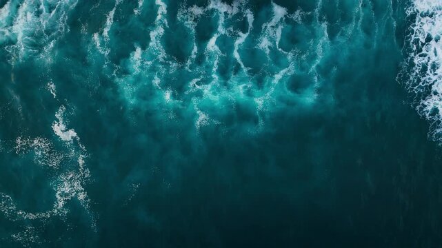Texture of big power dark ocean waves with white wash. Aerial top view footage of fabulous sea tide on a stormy day. Drone filming breaking surf with foam in Atlantic ocean