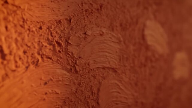 Closeup of Clay Wall With Swirls in Abstract Background Pattern