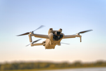 Flying drone above calm nature background