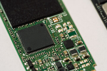 Macro of green M.2 SSD controller and electronic components. High quality photo
